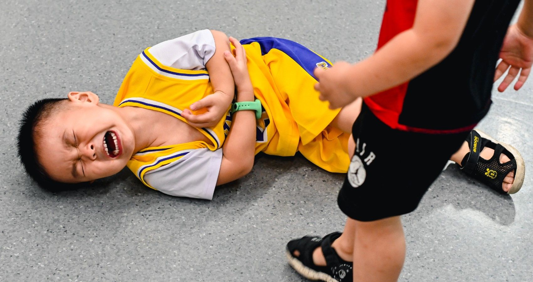 Two Children Fighting And One On The Ground 